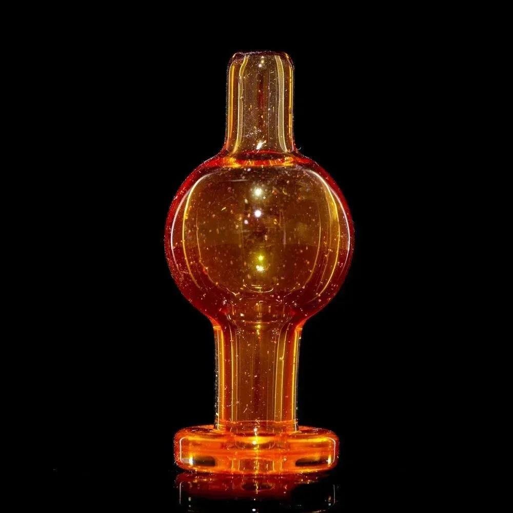 Tangelo orange glass bubble cap with sparkly accents, displayed on a black background.