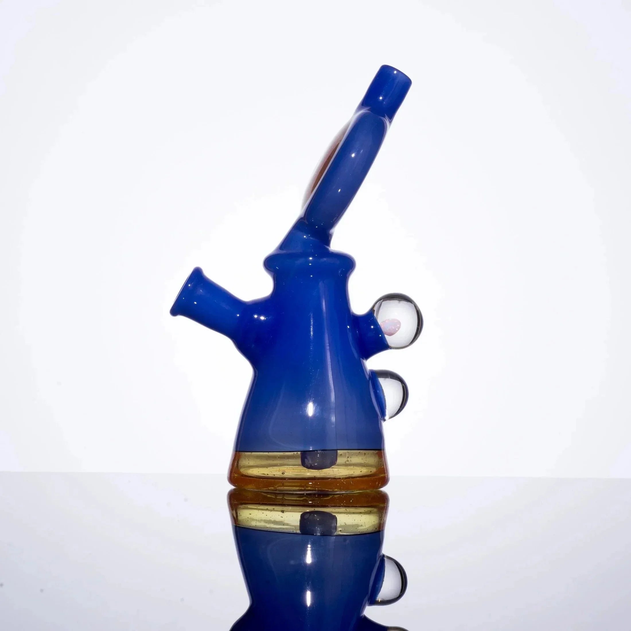 Blue and amber glass bong with dual chambers and side carb holes, studio shot