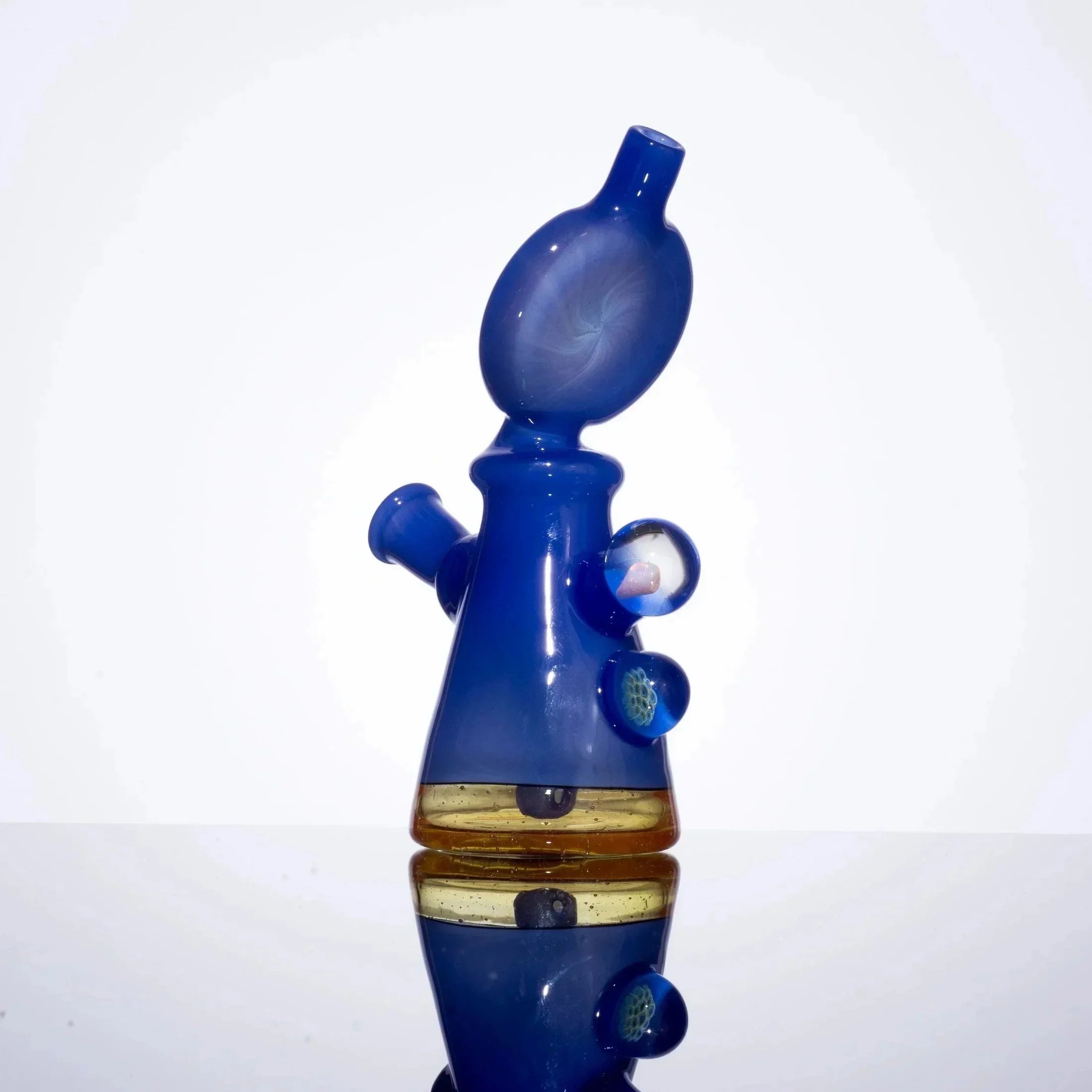 Blue heady glass bubbler with amber accent and decorative inclusions, studio shot