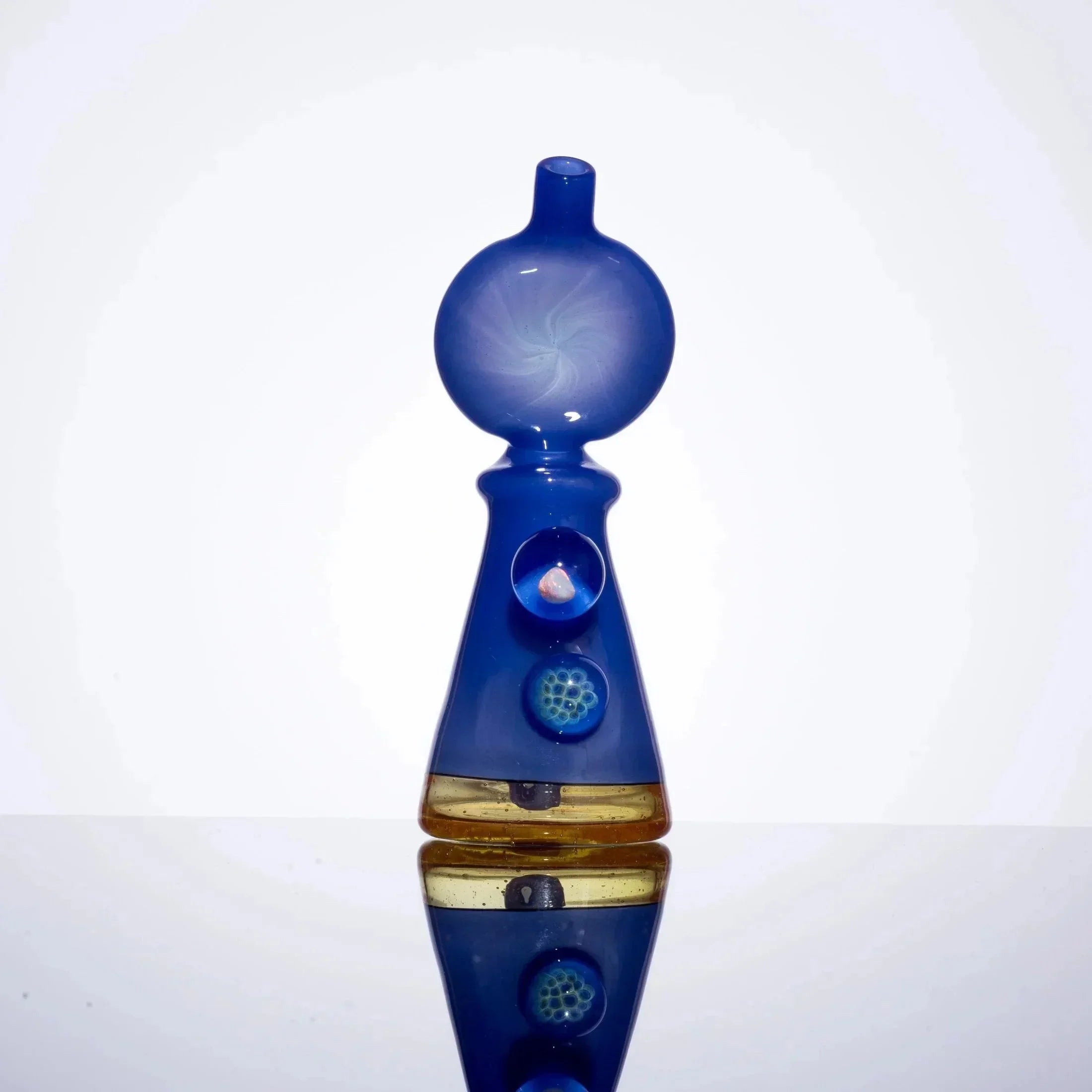 Blue heady glass pipe with swirl design and amber accent, featuring embedded decorative elements.
