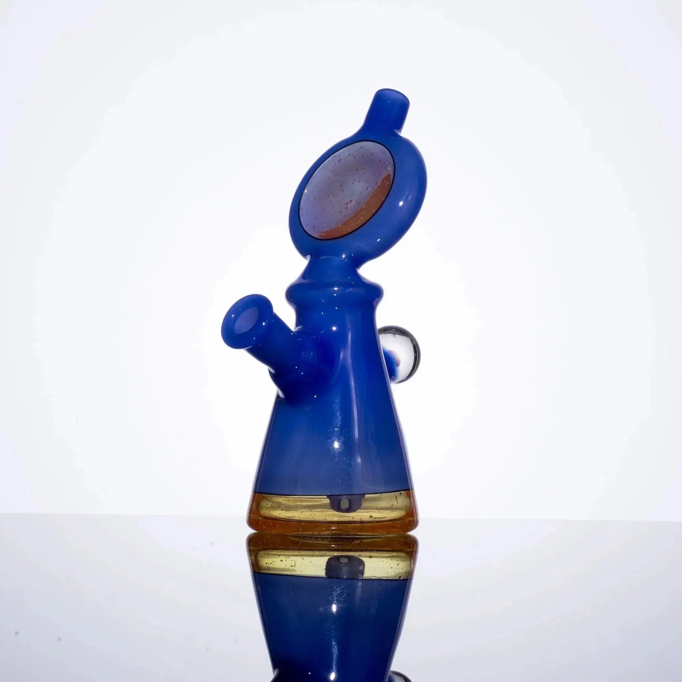 Vibrant blue and amber glass pipe with unique chamber design, showcasing heady glass artistry