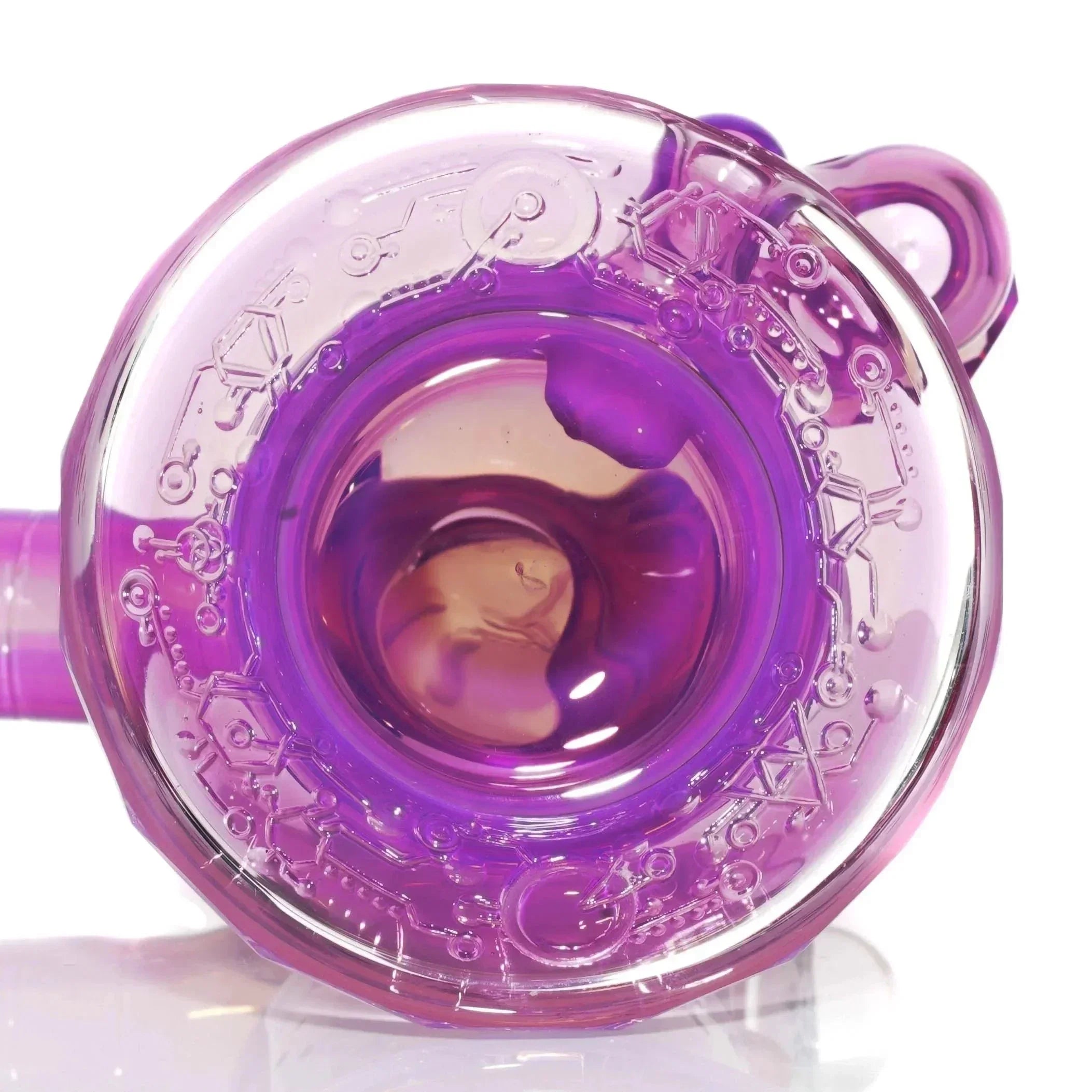 Close-up of a purple glass water pipe base with intricate etched designs