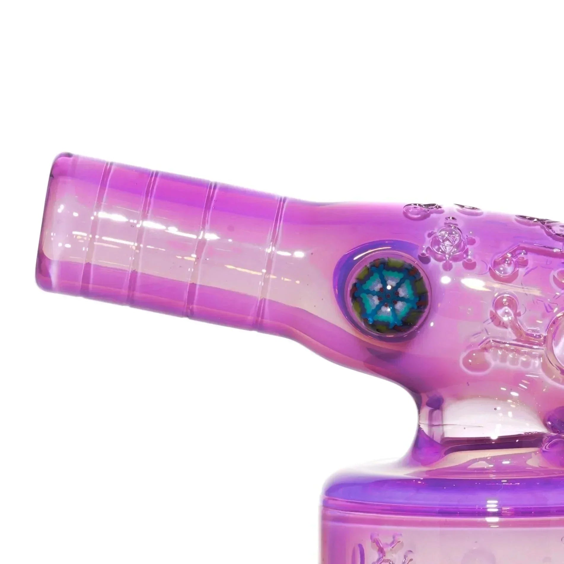 Close-up of a pink purple glass water pipe with embossed designs and colorful glass accent