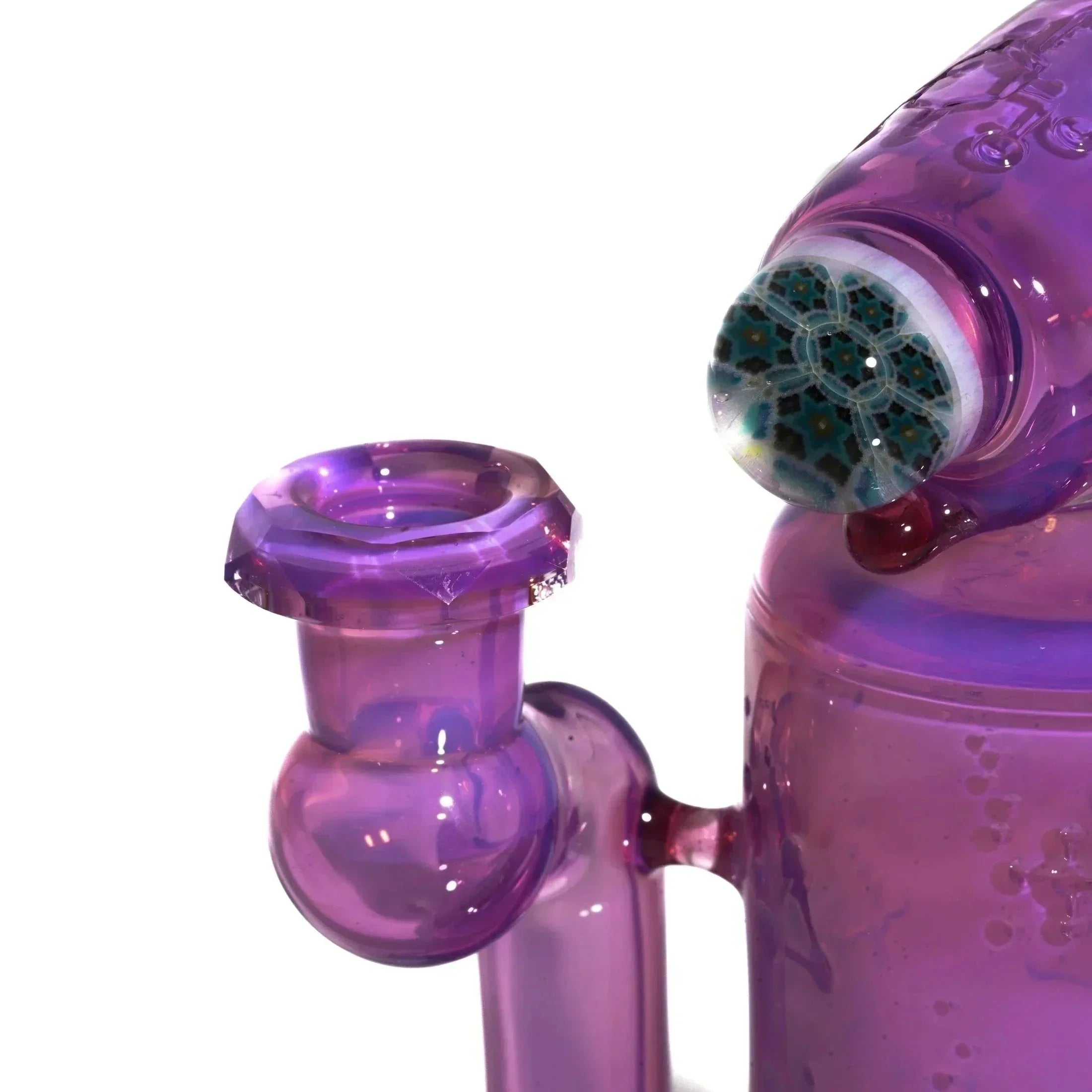Close-up of a purple glass water pipe with a geometric glass accent detail