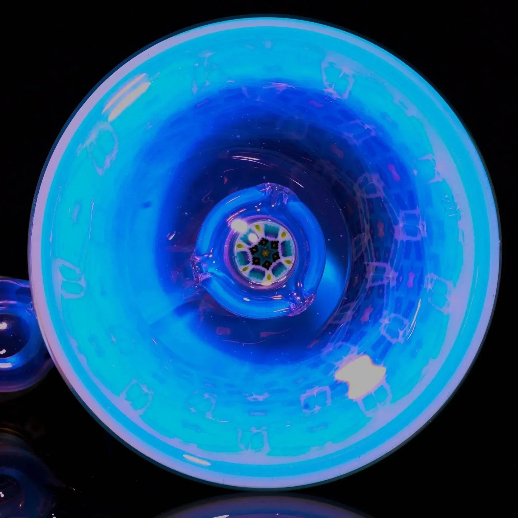 Blue UV reactive glass pipe bowl with intricate murrine art and glowing accents