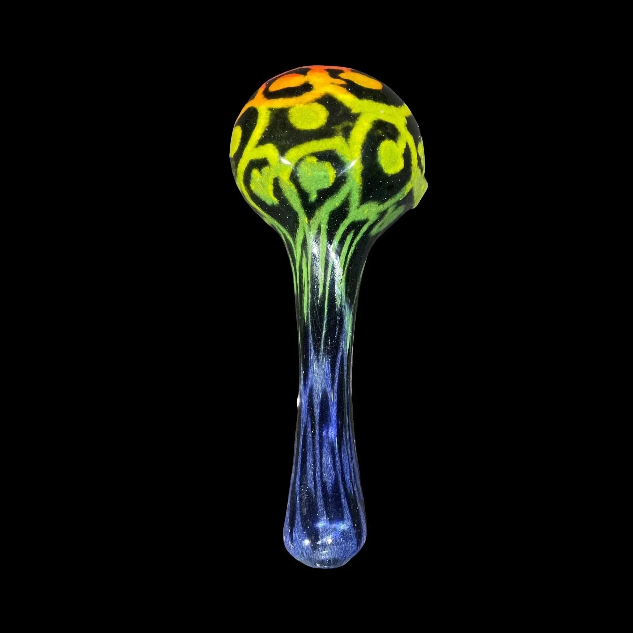 Hand-blown glass pipe with yellow, green, and orange patterns on a dark background.
