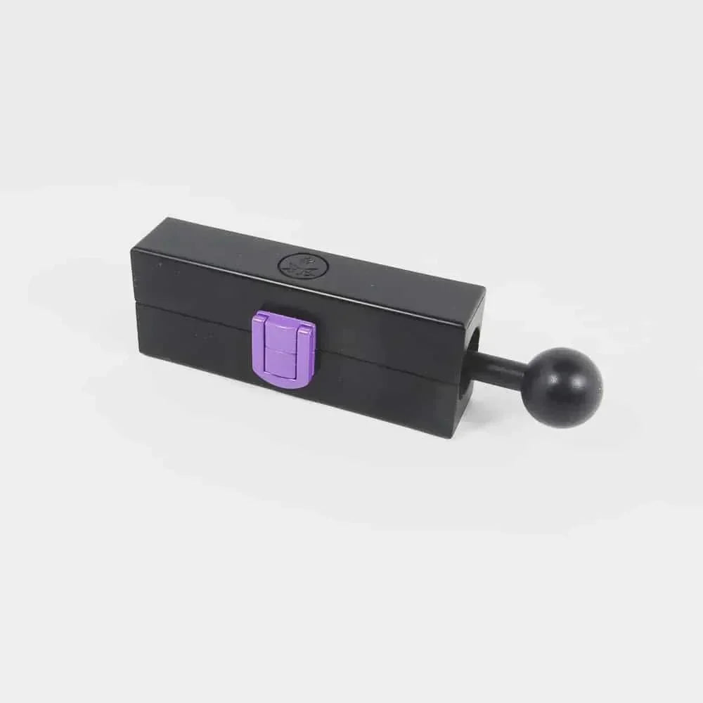 Black herb grinder box with purple latch and sliding handle, isolated on white background