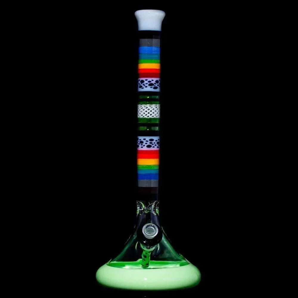 Colorful glass water pipe with rainbow stripes and intricate patterns on a black background