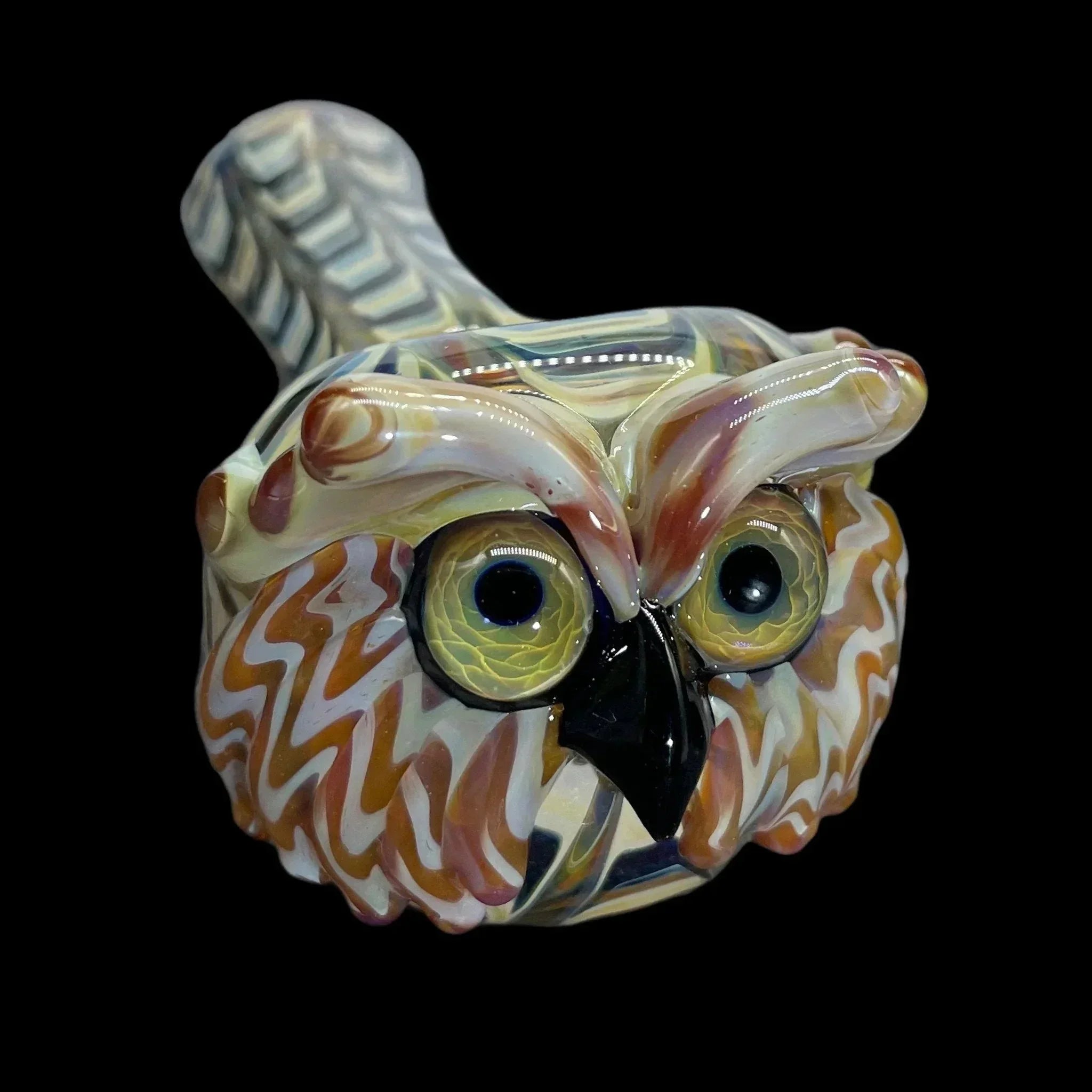 Hand-blown glass owl pipe with colorful details on a black background