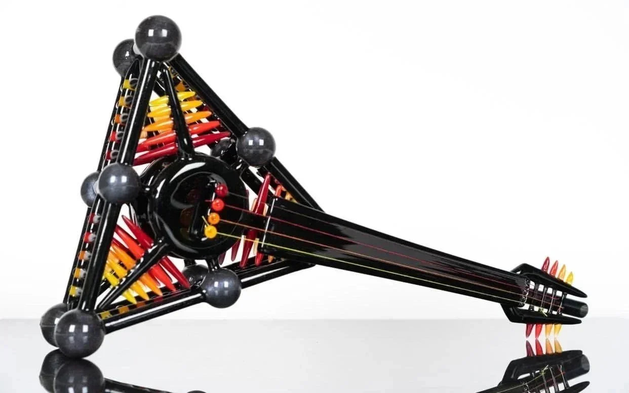 Black triangular glass pipe with colorful internal accents, heady glass art piece