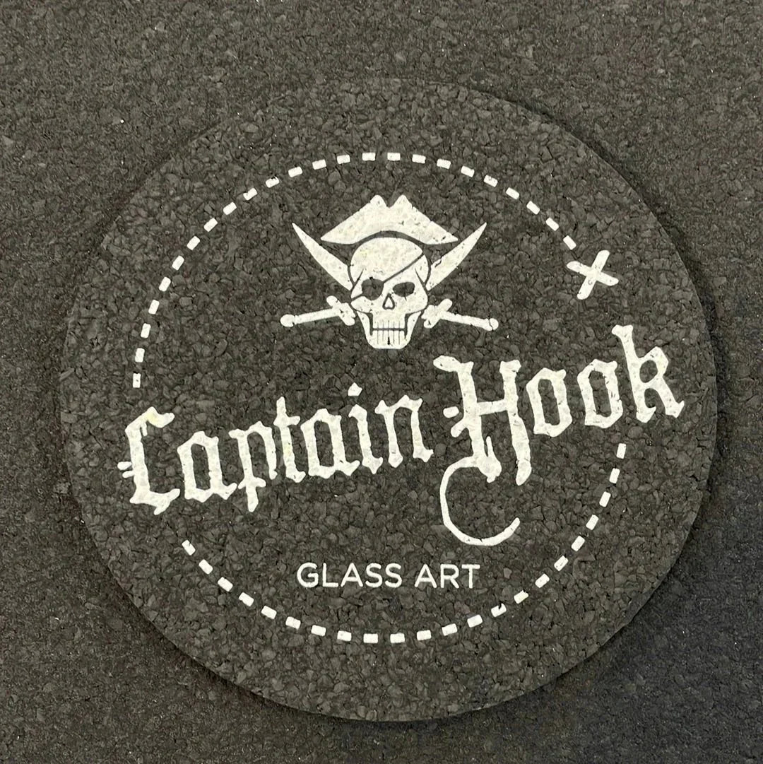 Captain Hook Glass Art round coaster with pirate skull and crossbones design on textured surface