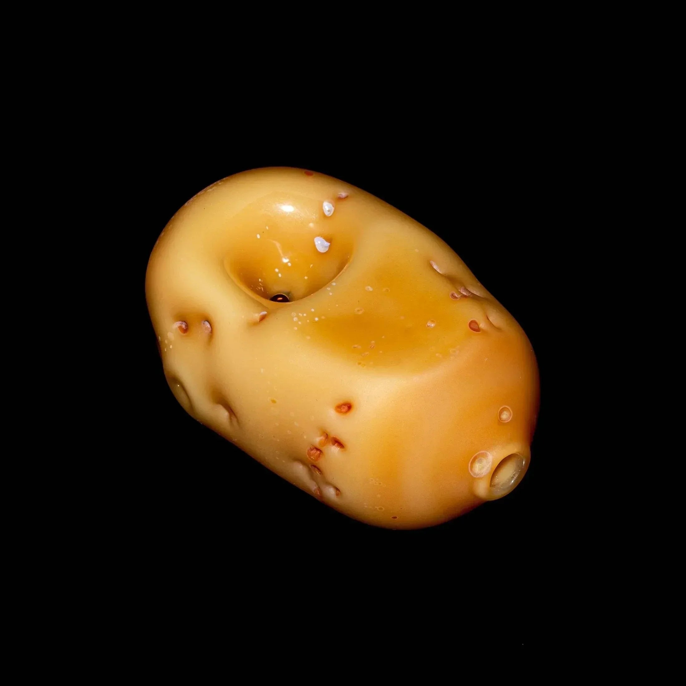 Realistic potato-shaped glass pipe with bowl and mouthpiece on black background
