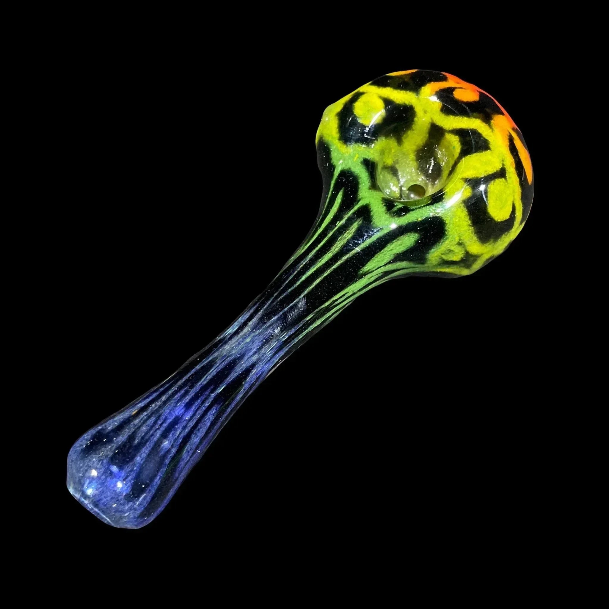 Colorful glass hand pipe with yellow, green, and orange swirl design on black background