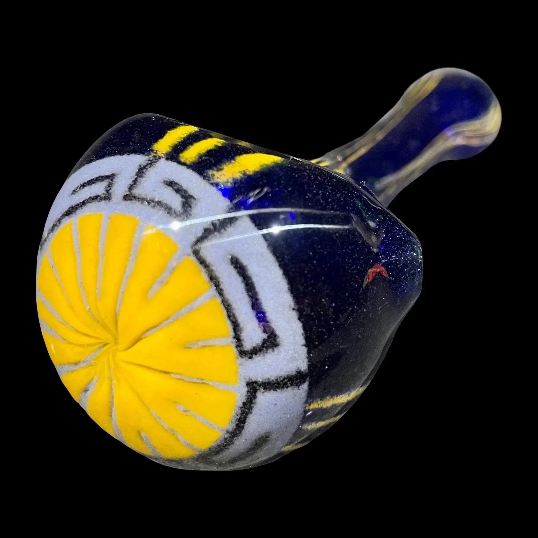 Hand-blown glass pipe with yellow sunburst and geometric designs on dark blue background