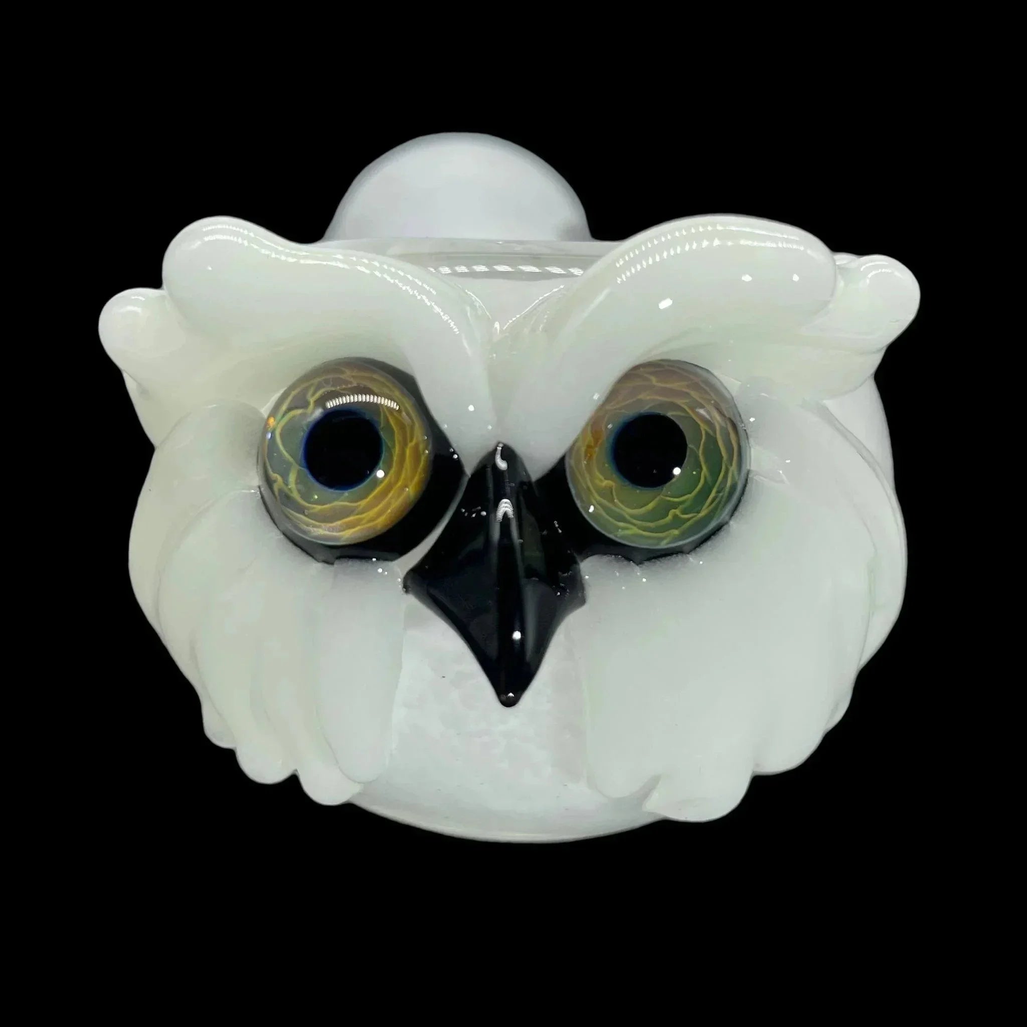 Handcrafted glass pipe shaped like a white owl with detailed eyes and beak on black background.