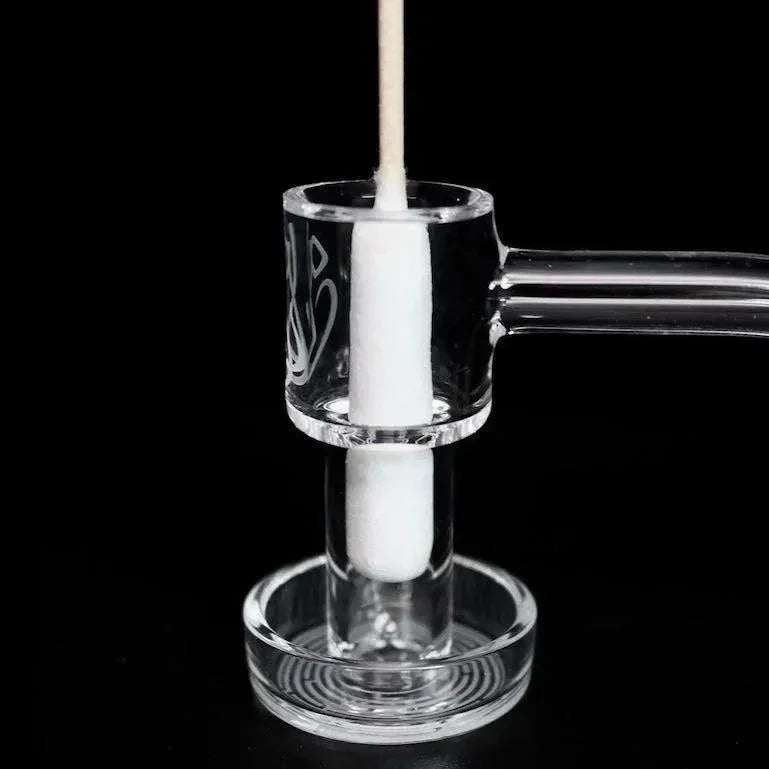 Clear quartz banger nail with cotton swab on black background, glass accessory for dab rigs
