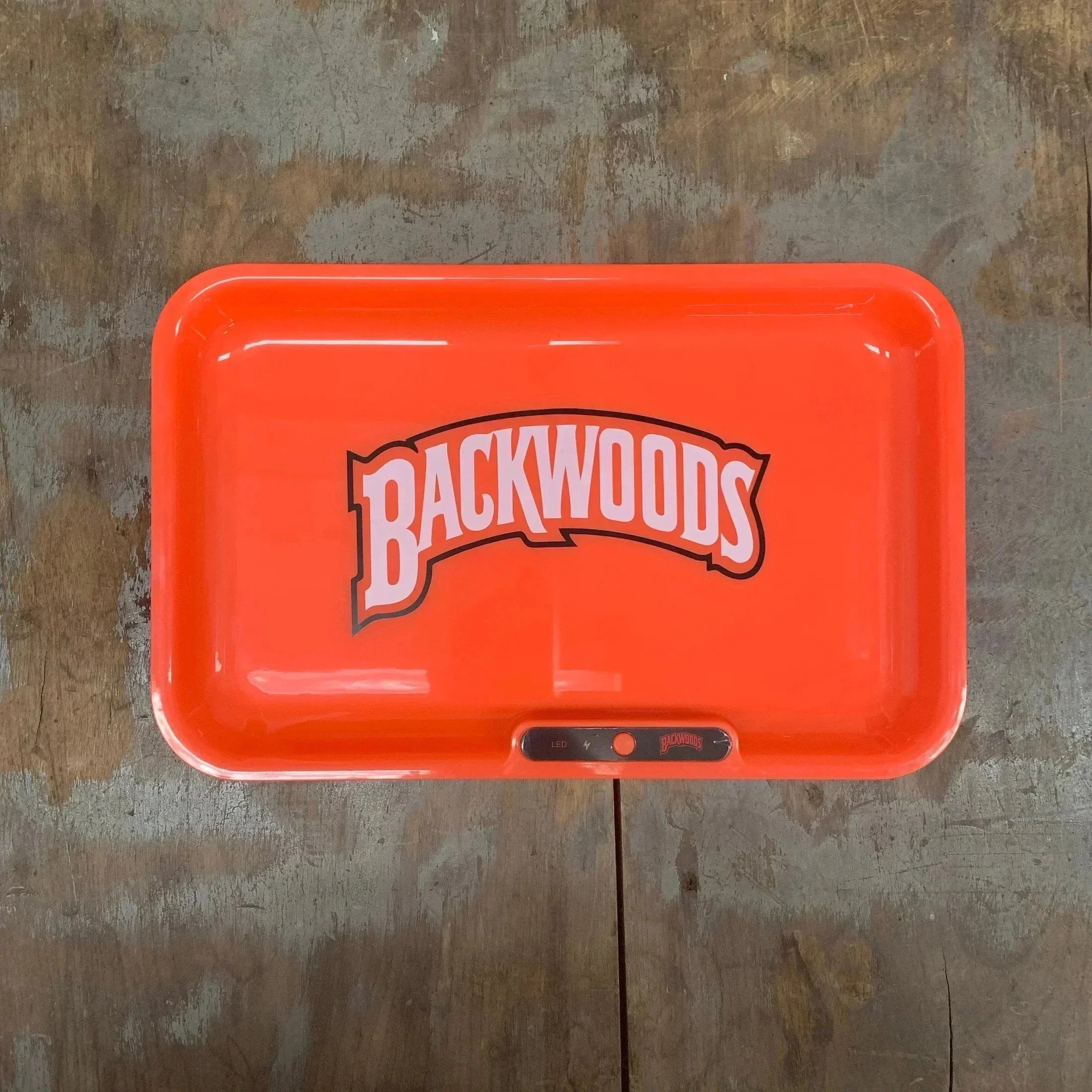 Bright orange Backwoods rolling tray with LED light, perfect for smoking accessories and vaporizer prep.