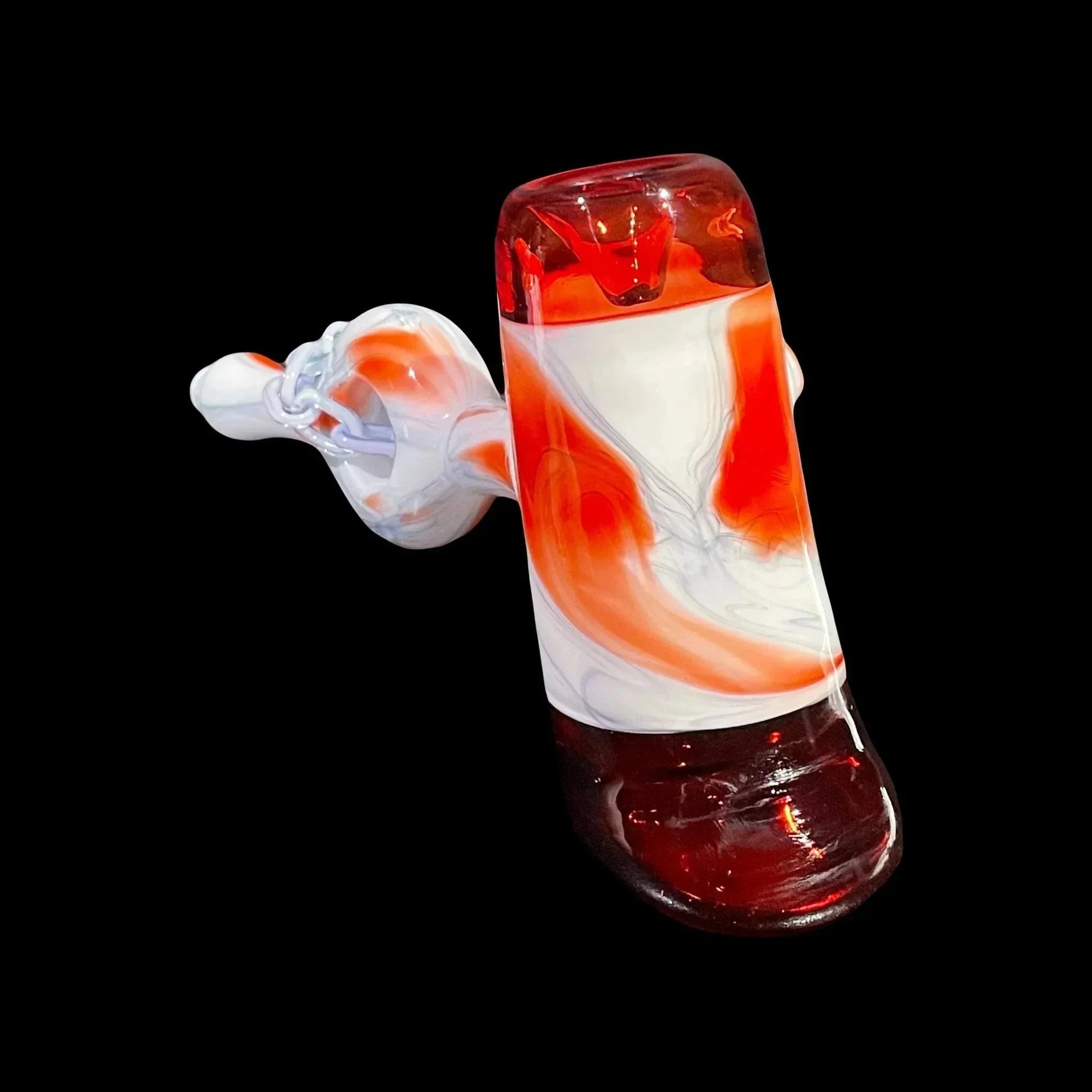 Red and white hand-blown glass pipe with marble swirl design on black background