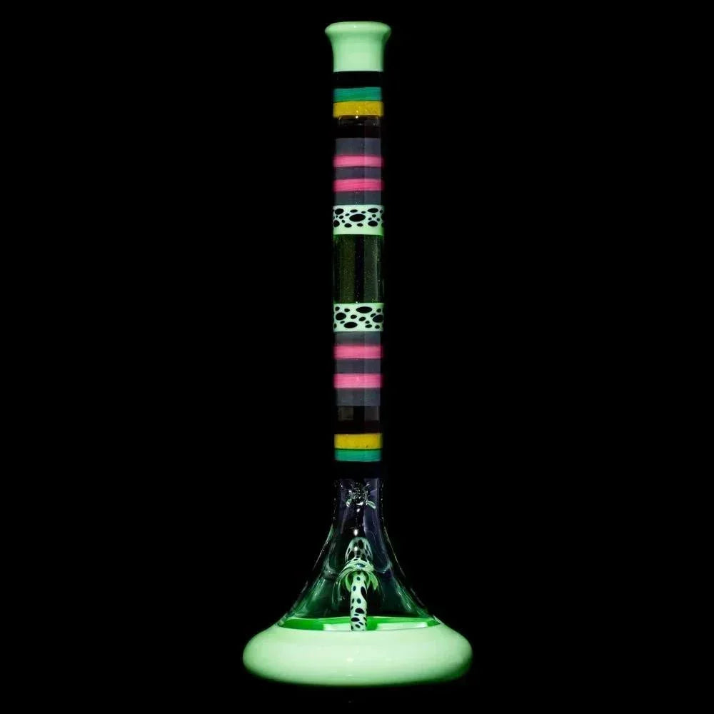 Colorful glass bong with striped and spotted patterns, wide base, on black background.