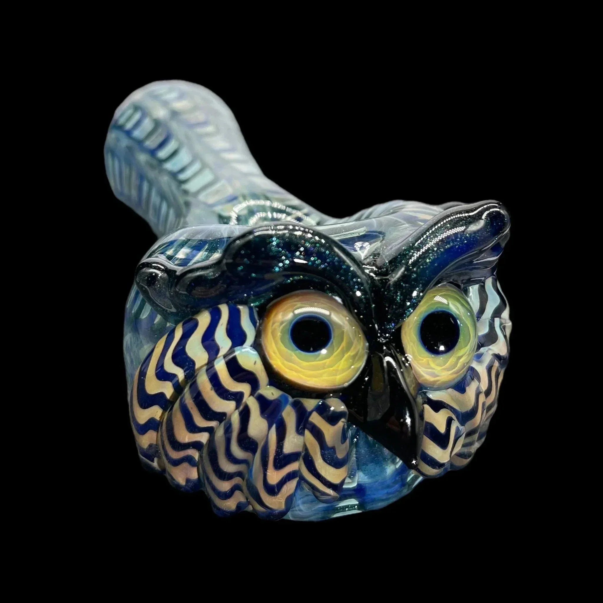 Hand-blown glass owl pipe with vibrant blue and yellow details on a black background
