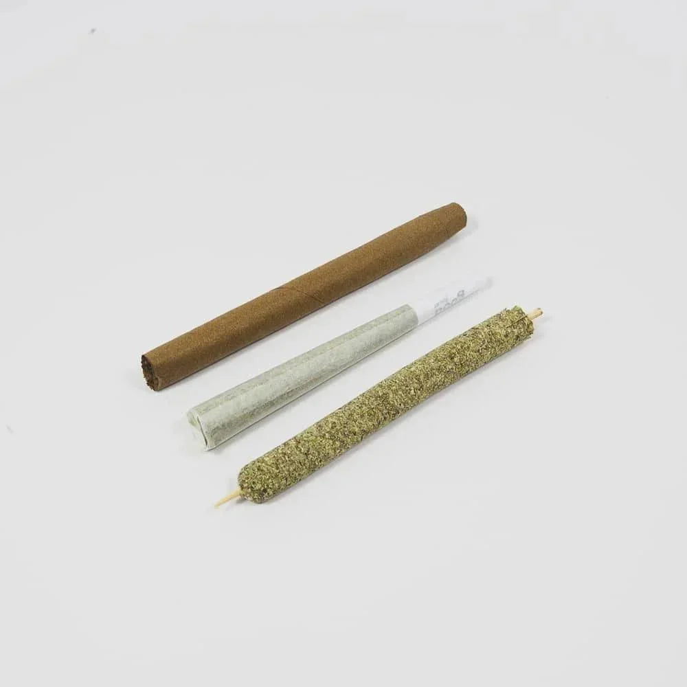 Three pre-rolled smoking cones on white background: hemp, paper, and natural wrap.