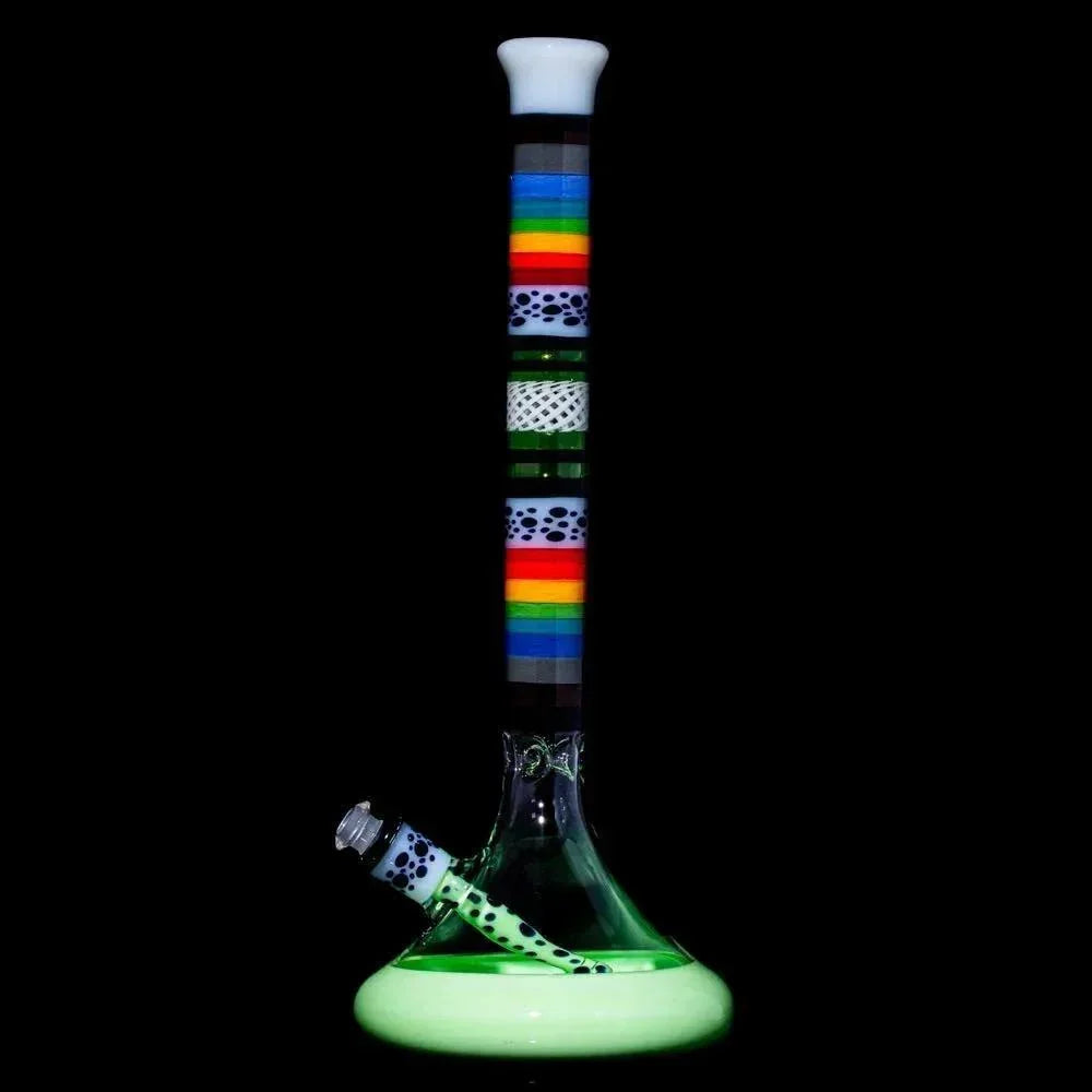 Colorful glass water pipe with rainbow stripes, polka dot accents, and green base