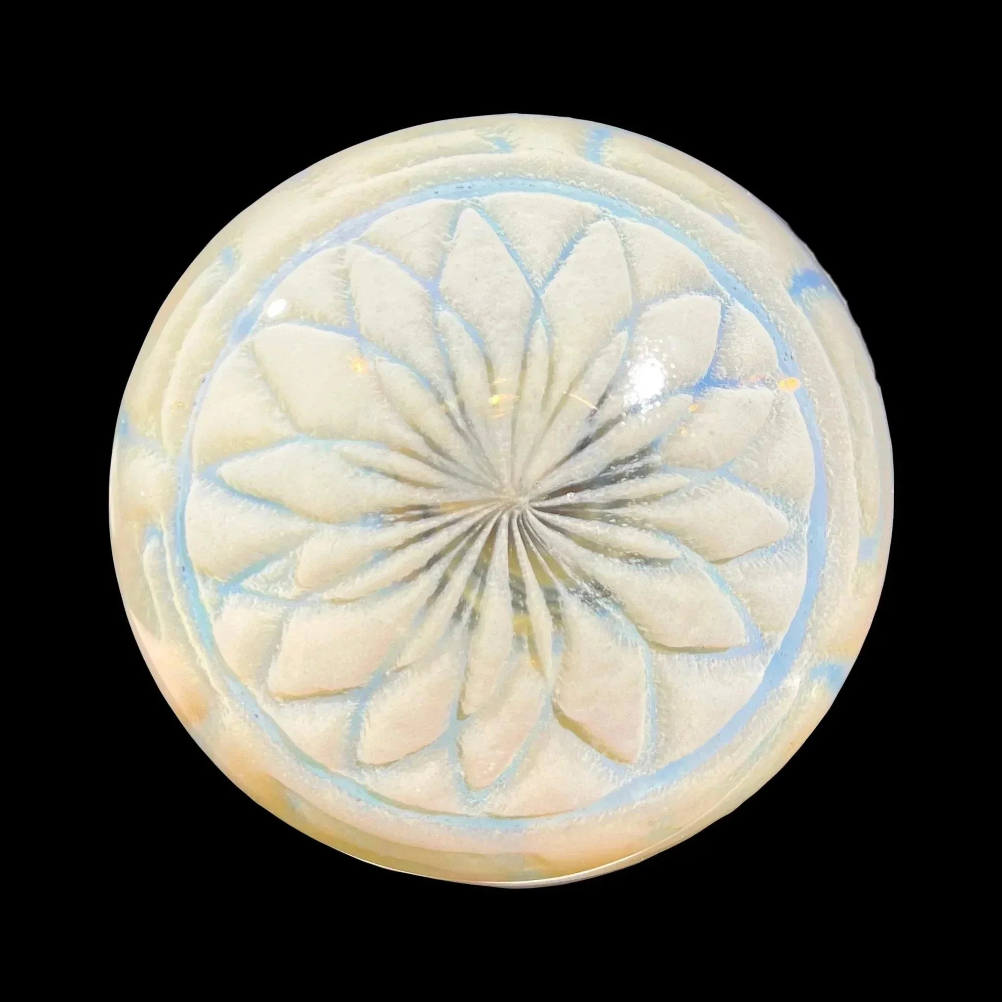 Iridescent glass carb cap with etched flower mandala design, viewed from above on black background