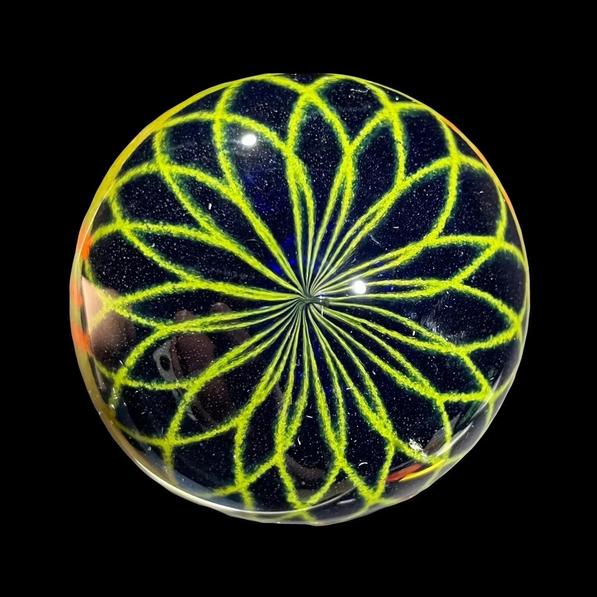 Handcrafted glass marble with intricate yellow and blue pattern, art glass accessory