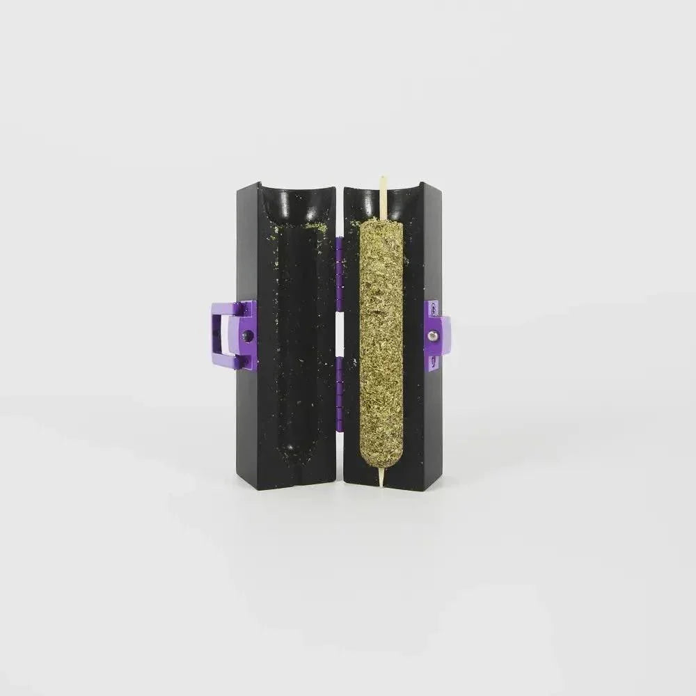Herb roller mold with packed herbal material, black case with purple hinges on white background.