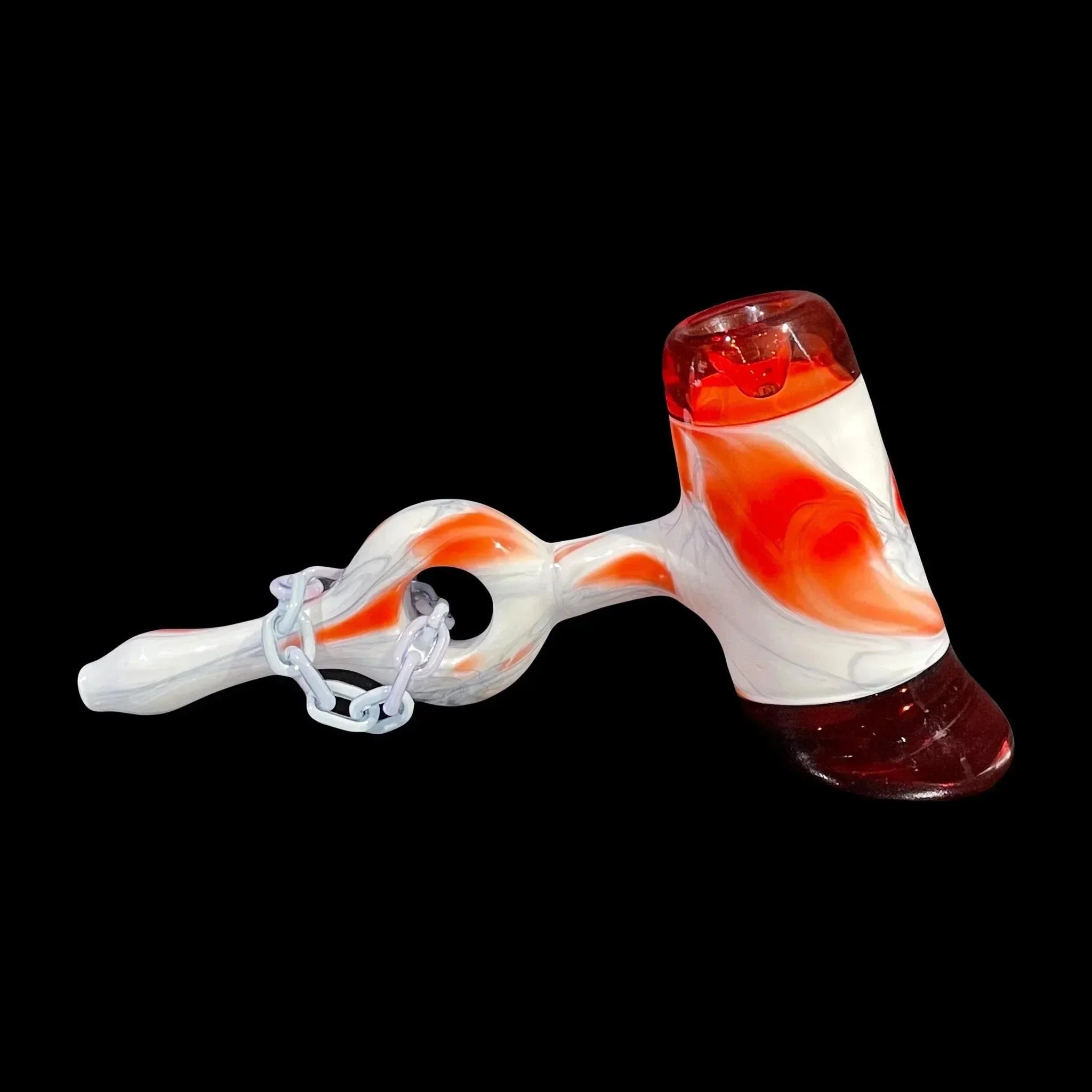 Artistic glass hand pipe with red, white swirls and decorative chain on black background