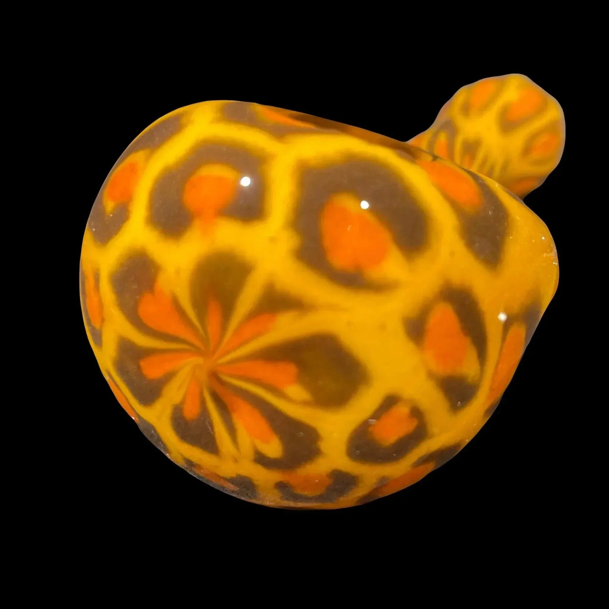Hand-blown glass carb cap with vibrant orange and yellow flower pattern, black background
