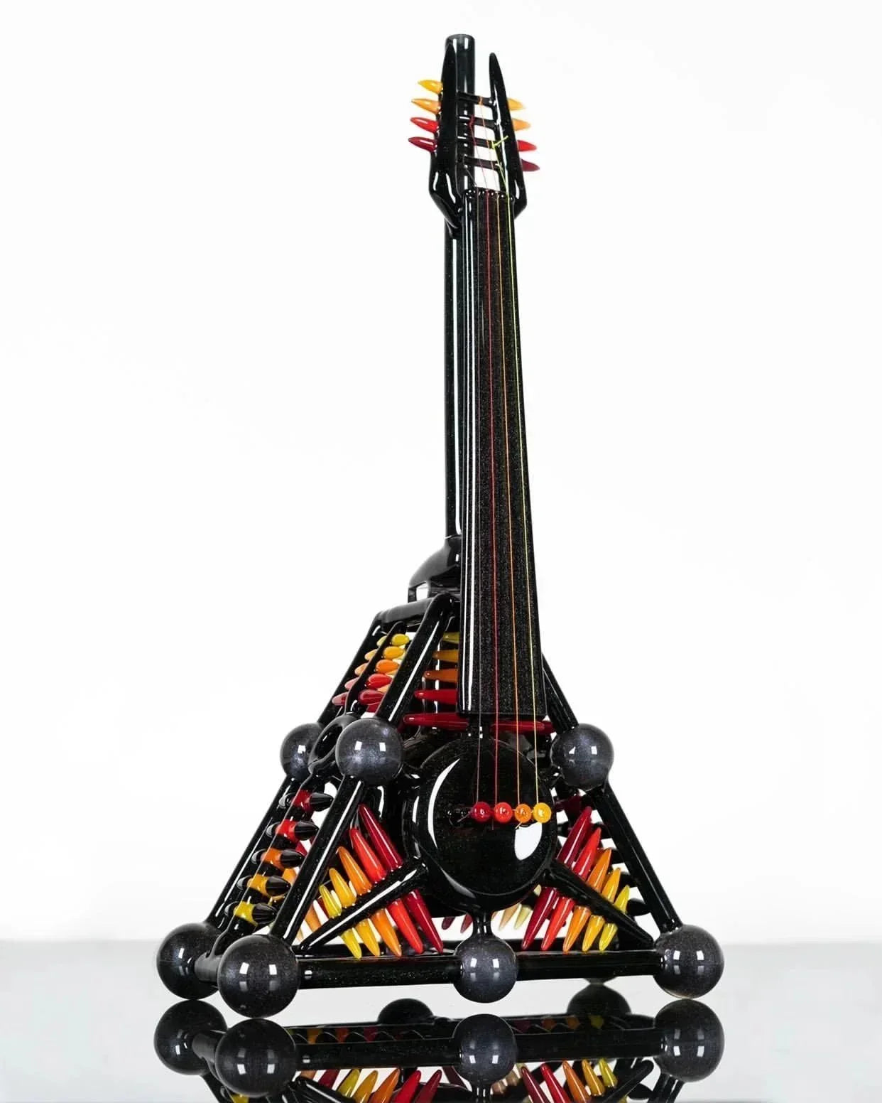 Artistic black glass bong shaped like Eiffel Tower with colorful accents, heady glass piece