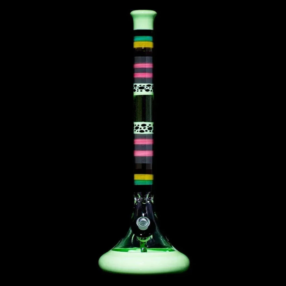 Tall glass water pipe with multicolor striped accents and unique patterns on a black background.