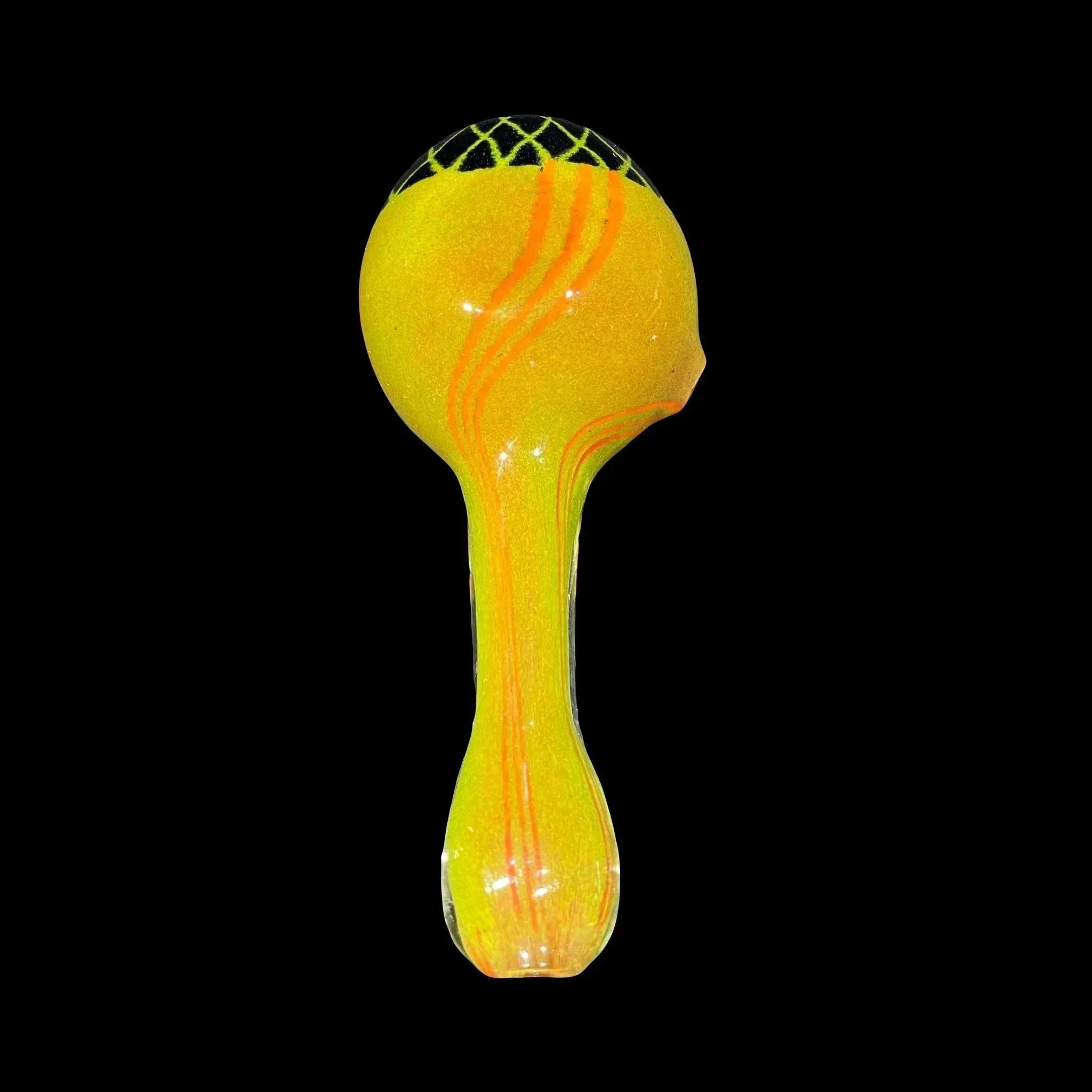 Yellow glass hand pipe with orange stripes and black grid design on the bowl, isolated on black