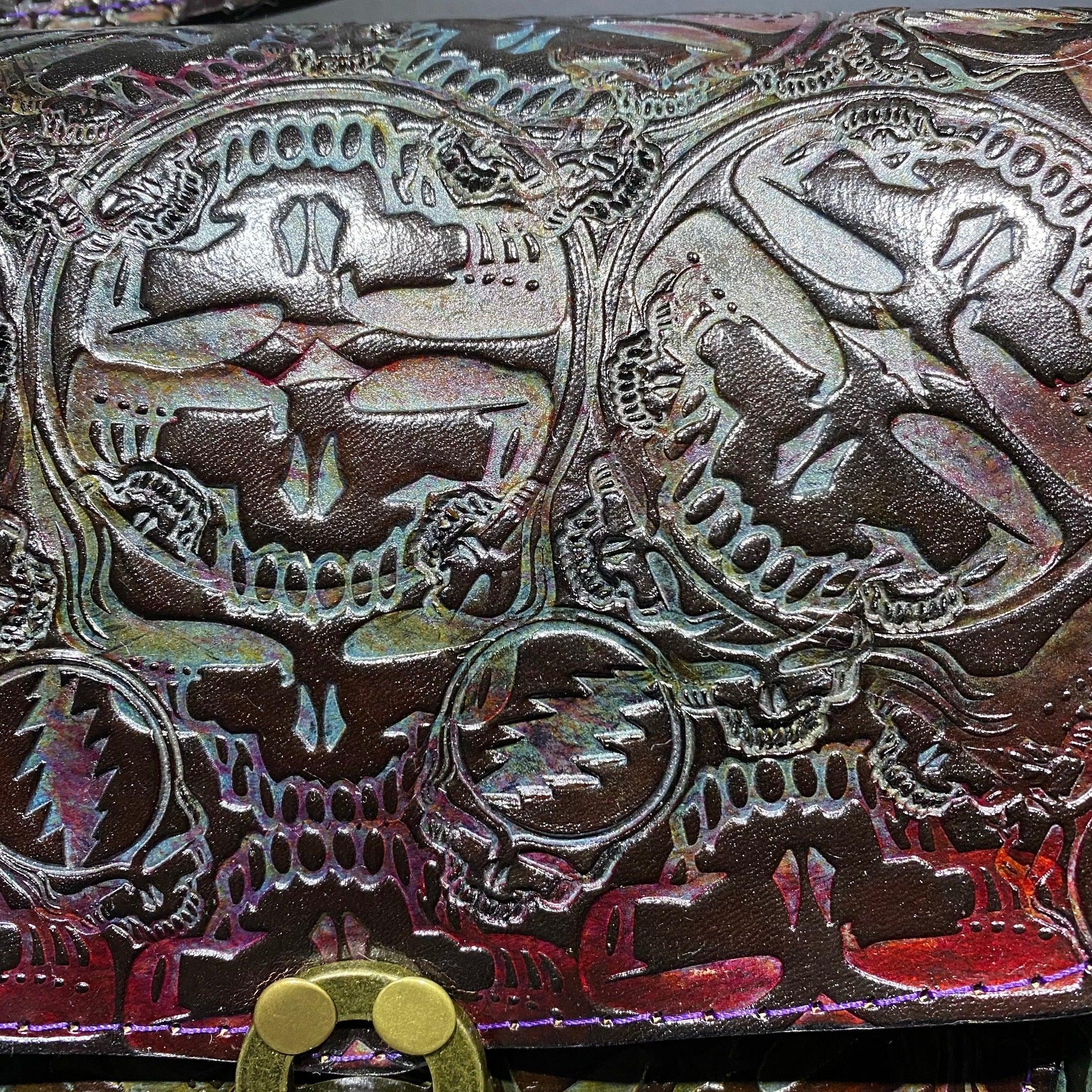 Embossed leather design featuring iridescent skulls and lightning bolt patterns.