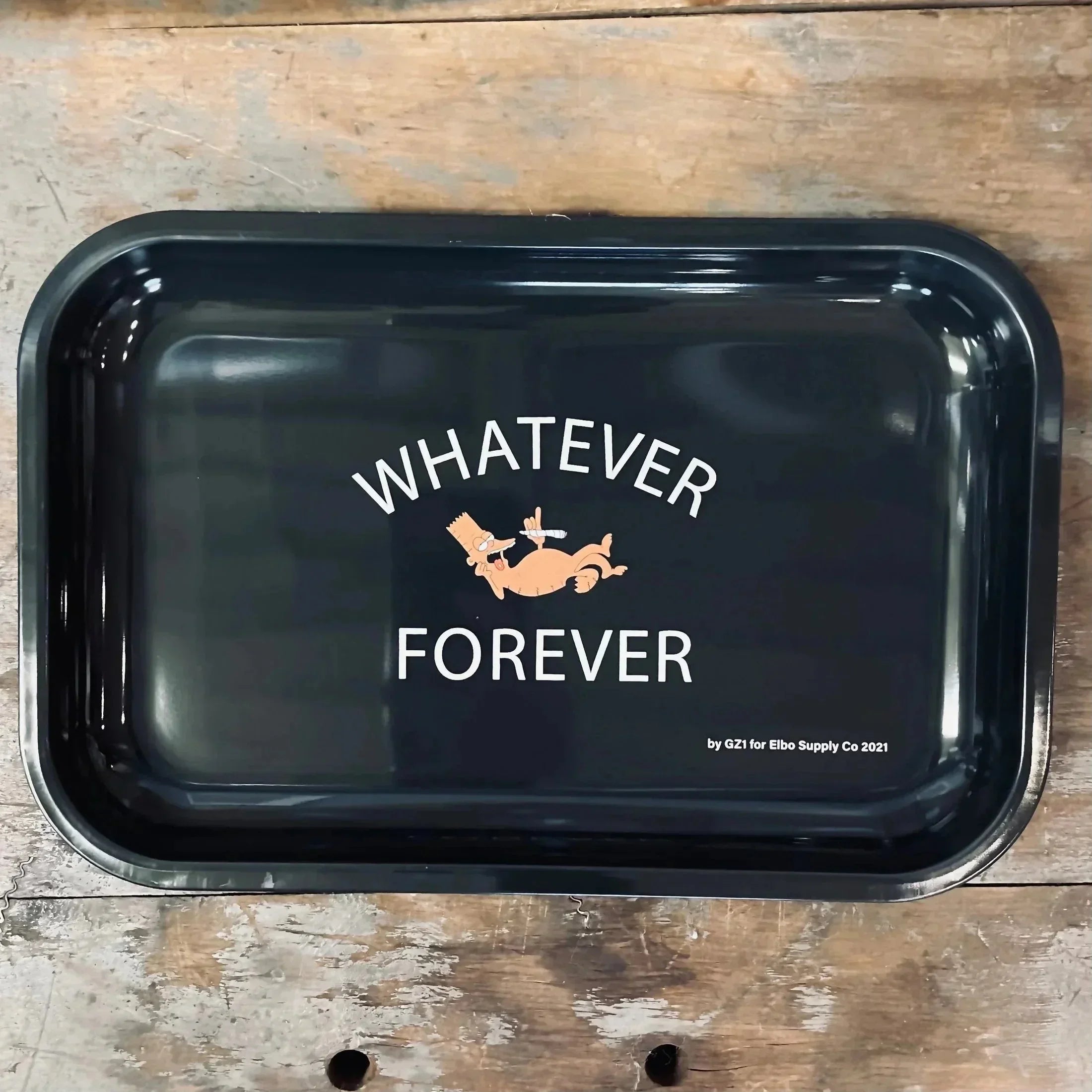 Black metal rolling tray with cartoon graphic and 'Whatever Forever' text on rustic wood background