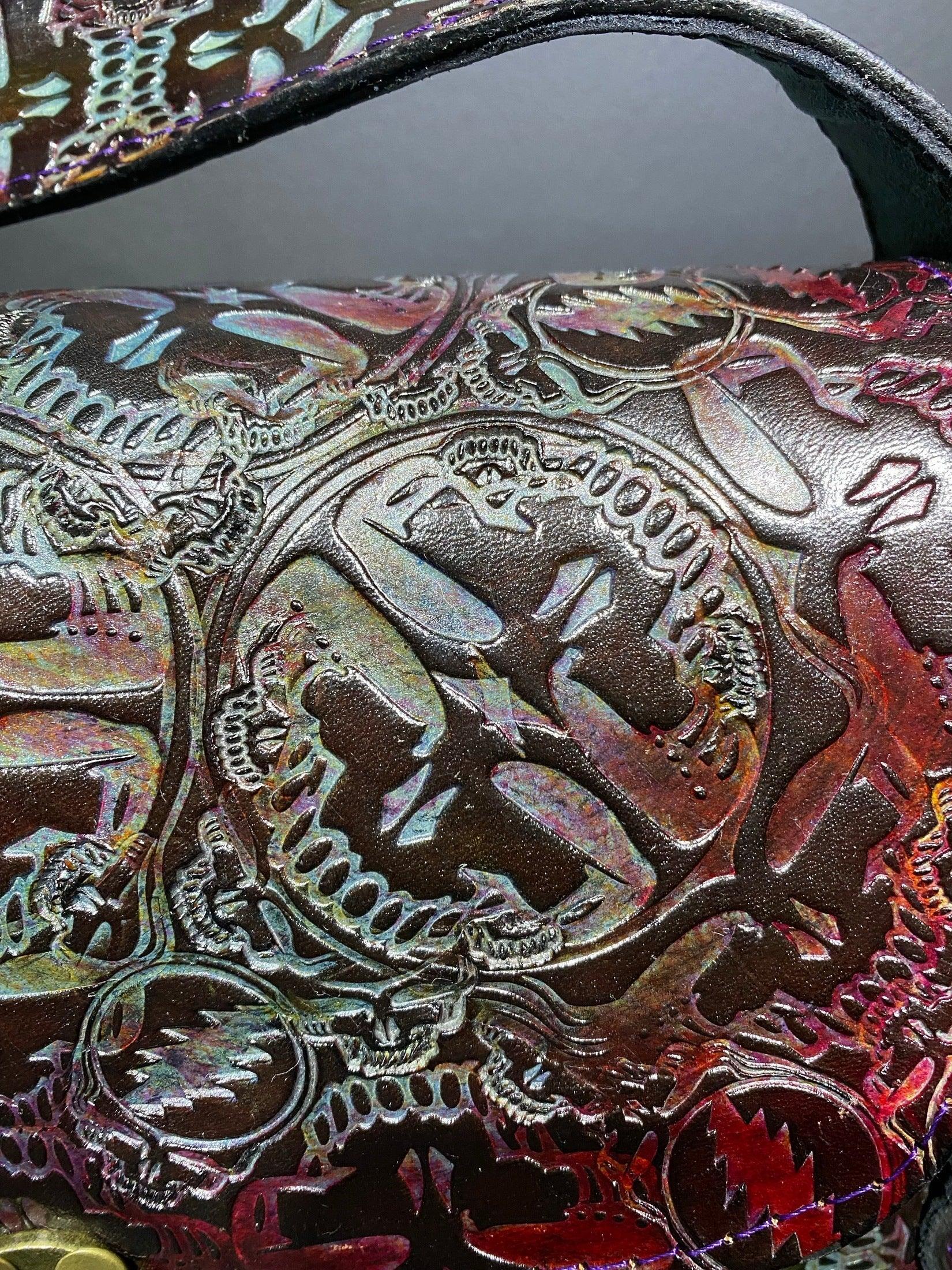 Close-up of holographic embossed leather with intricate skull and lightning bolt designs