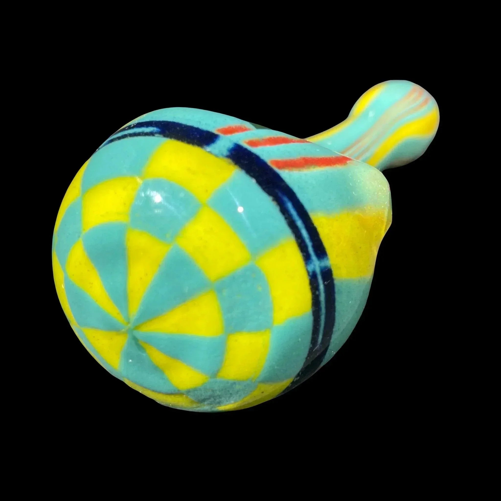 Hand-blown glass pipe with blue and yellow geometric pattern on black background