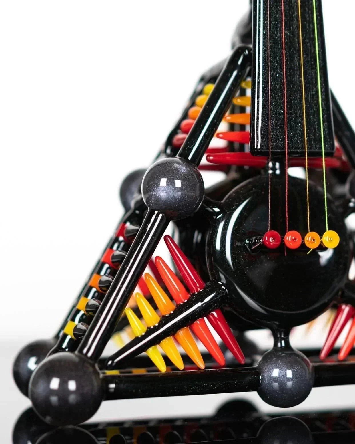 Black glass bong with rainbow accents, spiked percolator, and colorful beads for heady glass collection