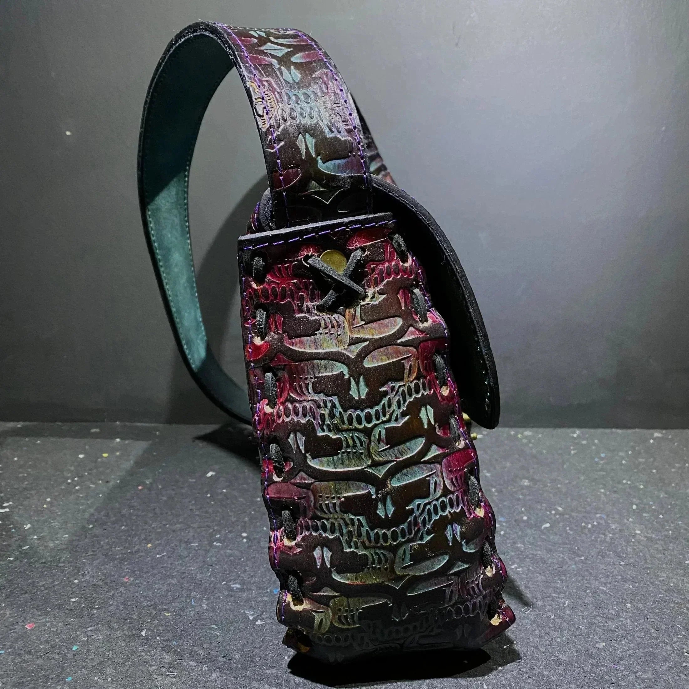 Handcrafted leather pouch with multicolor skull pattern and stitched details