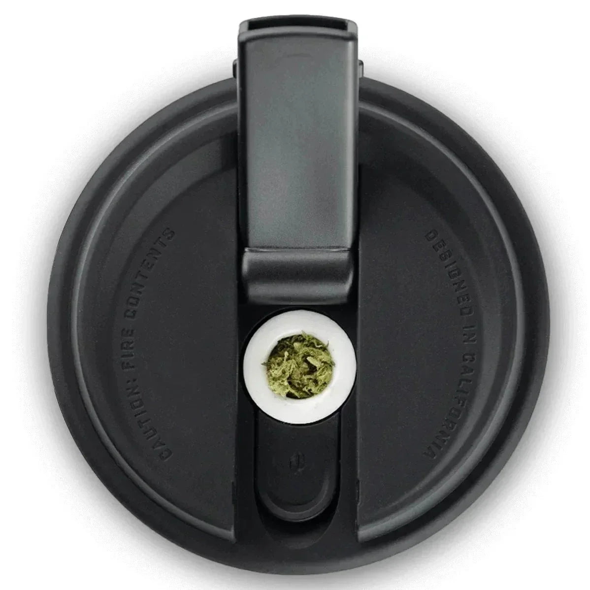 Black vaporizer lid with built-in loading tool and ceramic chamber containing green herbs