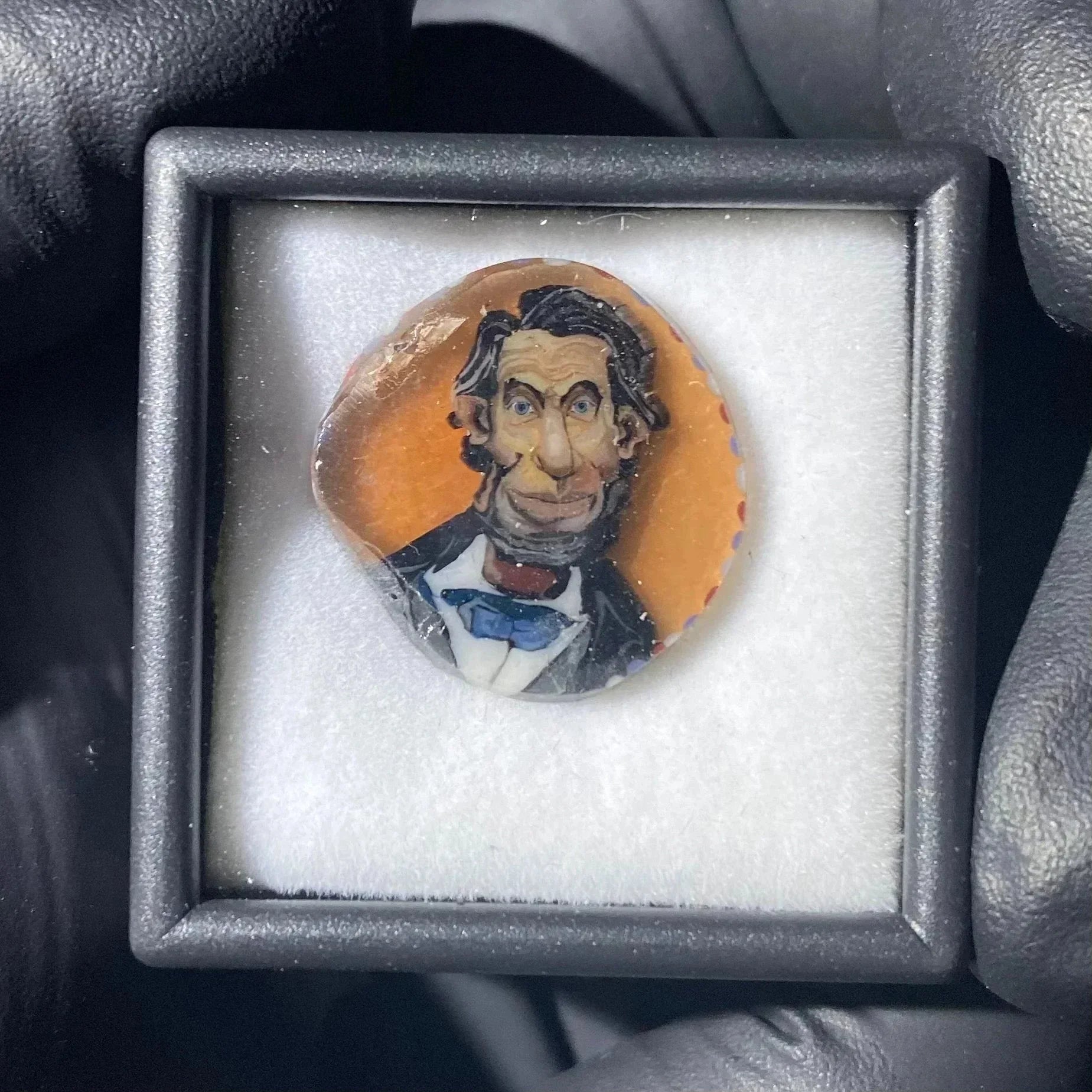Handmade glass pendant with a caricature portrait encased in a presentation box