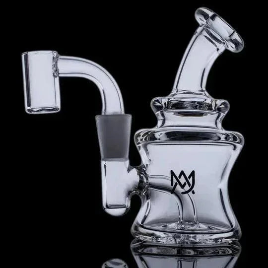 Clear glass mini dab rig with angled mouthpiece and quartz banger on black background