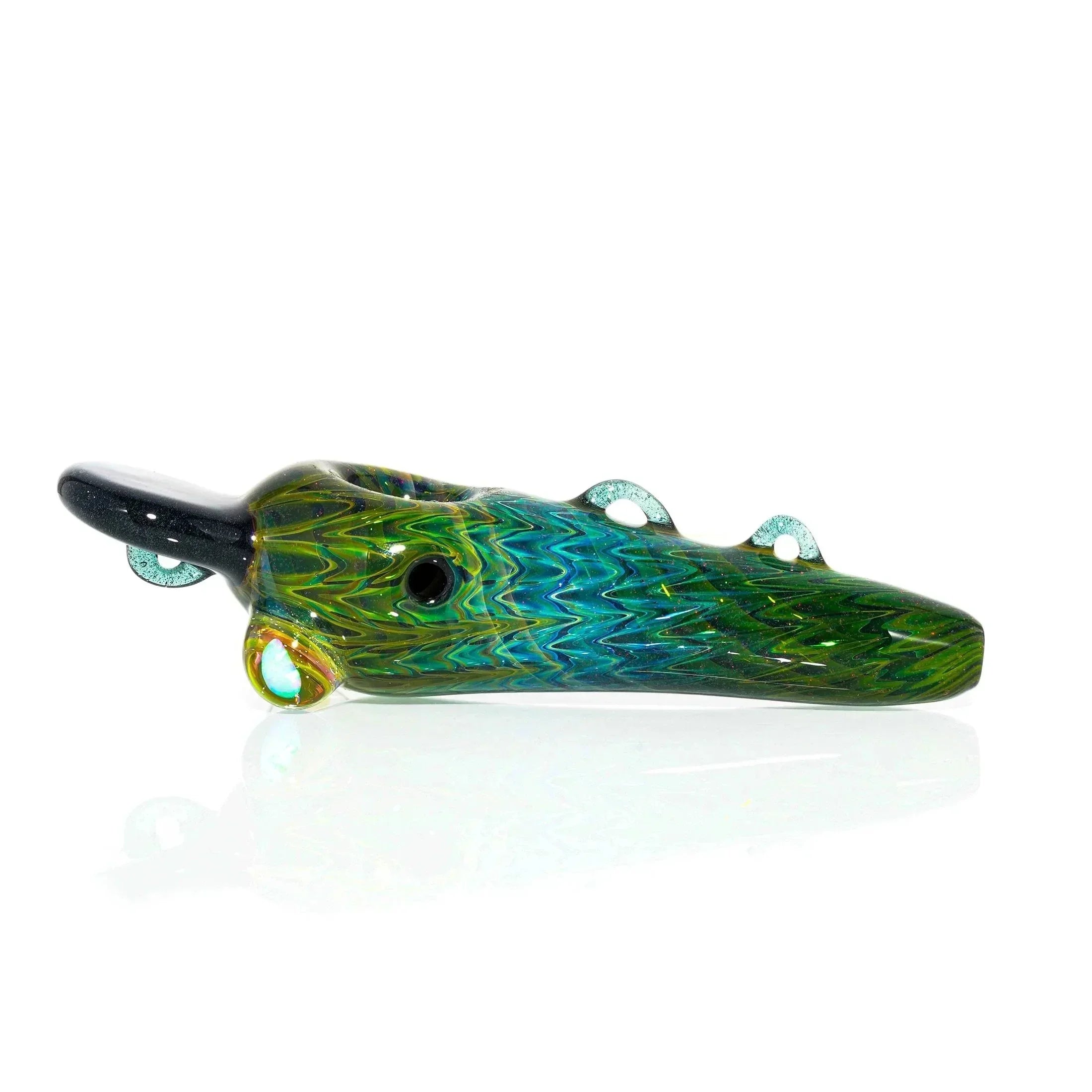 Green and blue glass hand pipe shaped like a fish, displayed on a white background.