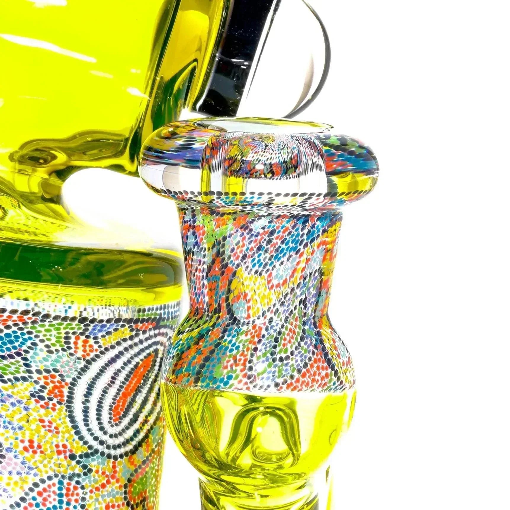 Colorful hand-blown glass pipe with intricate dot patterns and yellow accents