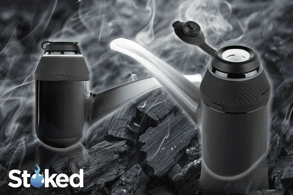 Modern glass smoking pipes on charcoal with swirling smoke, stylish vaporizer accessories