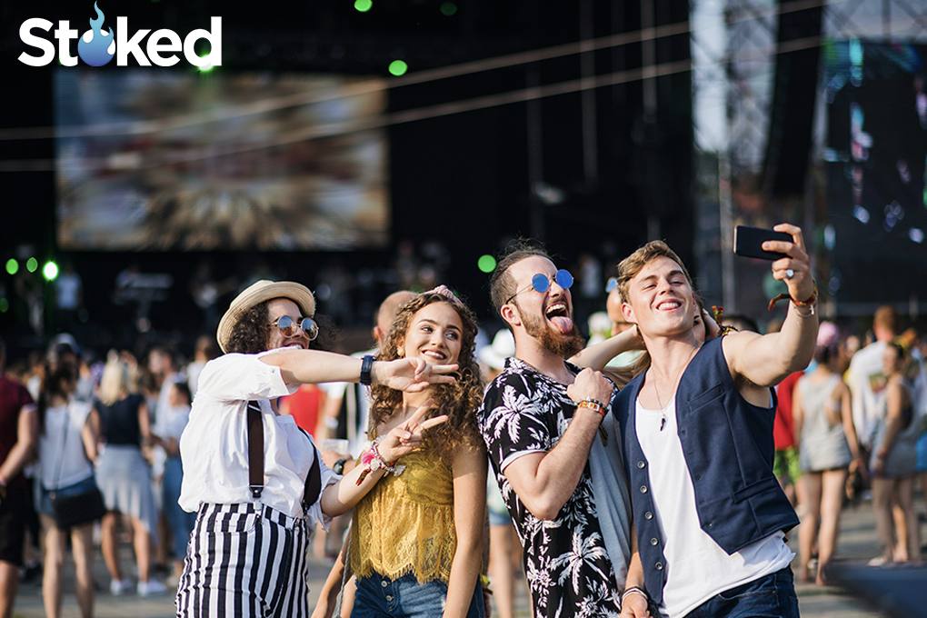 Group of friends taking a selfie at a music festival