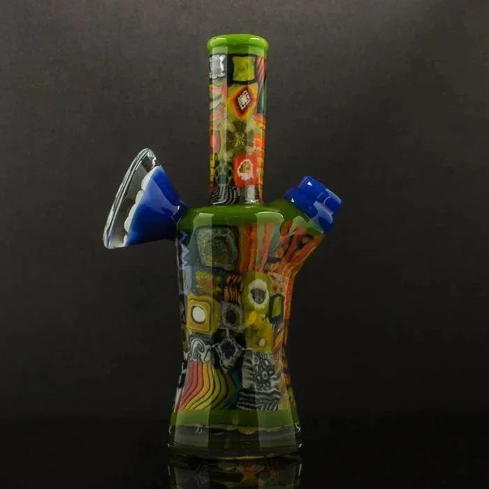 Colorful patchwork glass water pipe with geometric patterns on black background