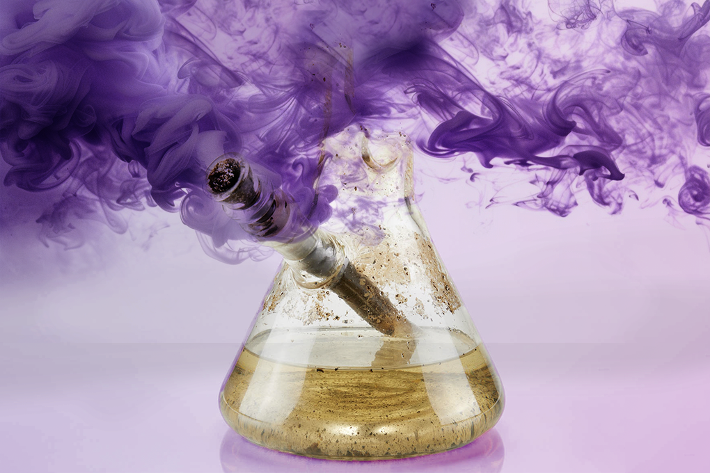 Moldy bong with purple smoke behind it.