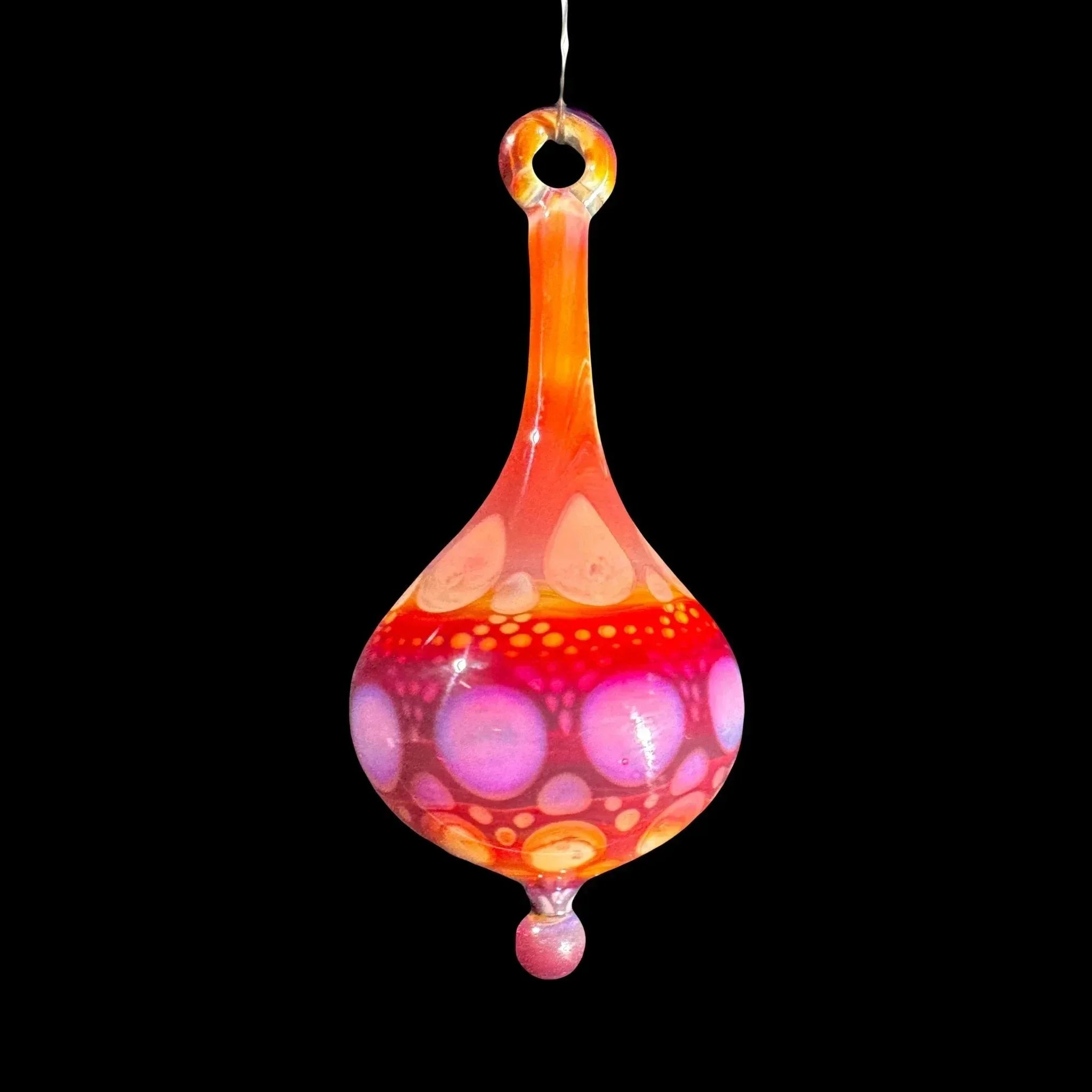 Hand-blown glass pendant with pink, orange, and purple bubble patterns on black background